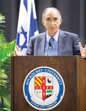 Courtesy of Rockhurst University: With the Israeli flag behind him, Israel’s Ambassador to Vatican City, Zion Evrony, Ph.D., spoke at Rockhurst University last week as part of its Visiting Scholar Lecture Series. He also spoke at the annual interfaith clergy institute, co-sponsored by the Jewish Community Relations Bureau|American Jewish Committee.